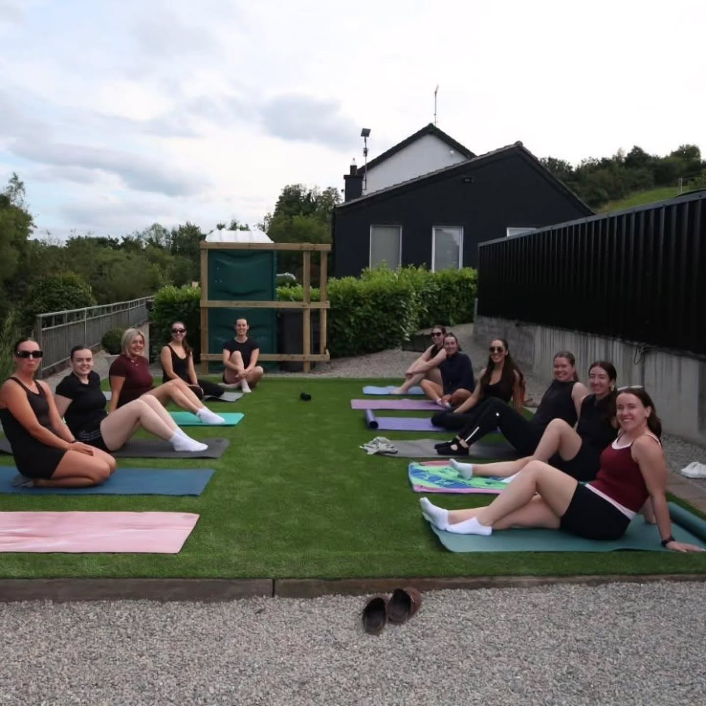 A group relaxing together on the lawn after a class