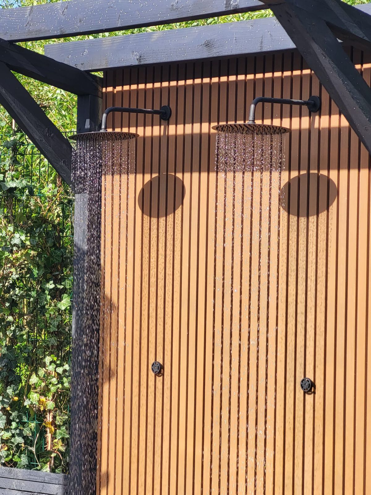 Outdoor rain showers on a timber screen